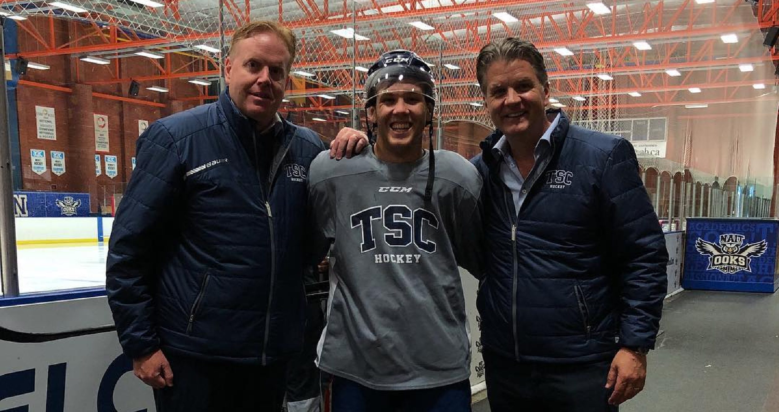 The Sports Corporation Gerry Johannson and Scott Boner with New Jersey Devils NHL Player Ty Smith